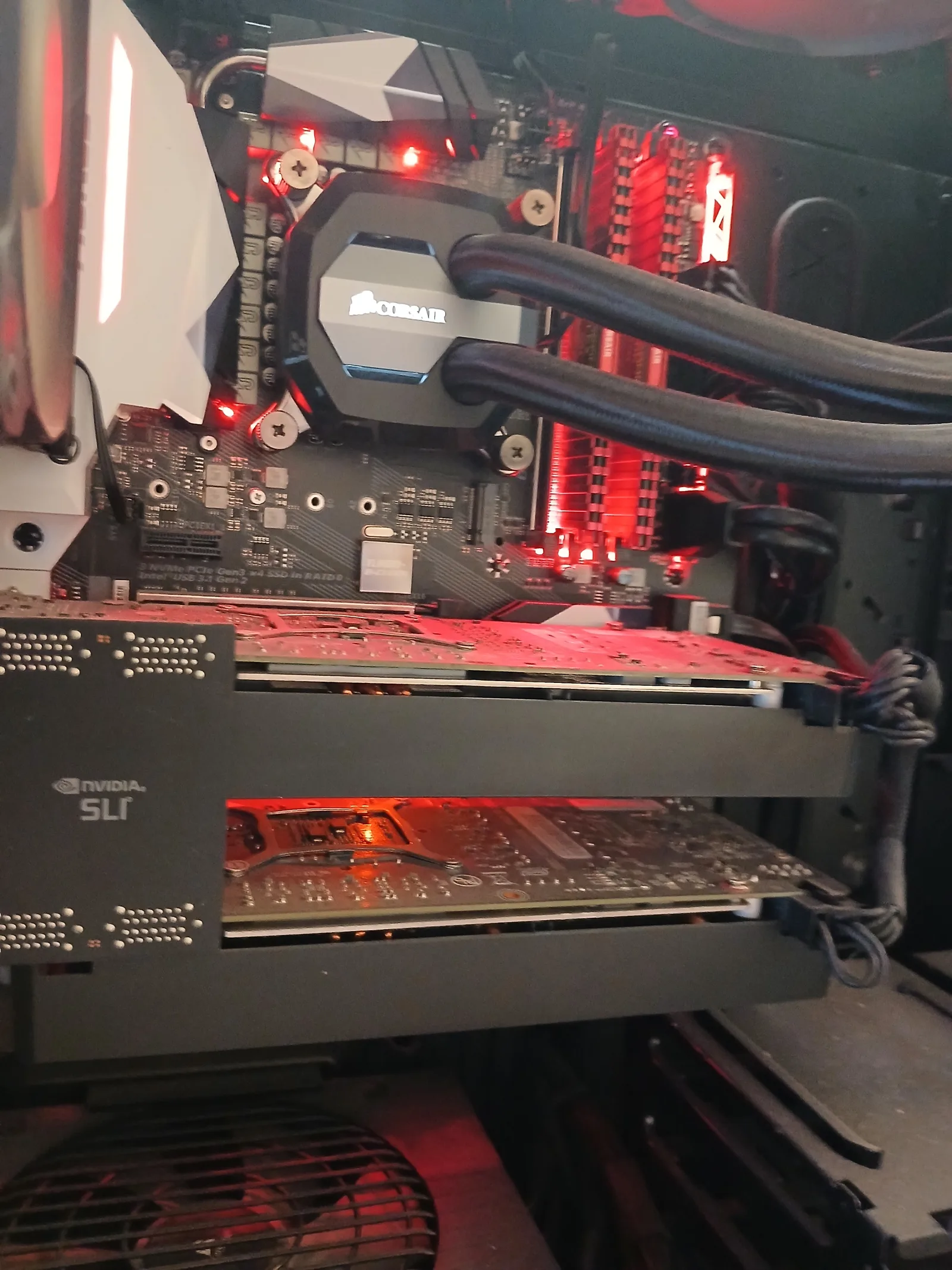 Dual NVIDIA graphics cards bridged in SLI inside a custom red-themed PC on the workshop bench in Harold Hill, Romford